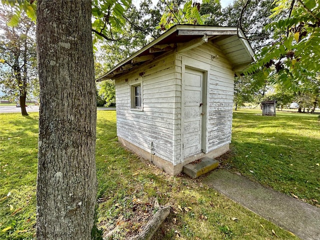 view of outbuilding with a yard