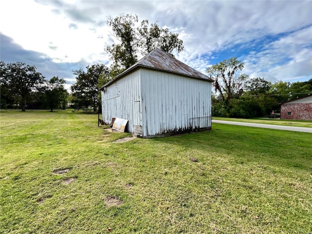 view of outbuilding featuring a yard