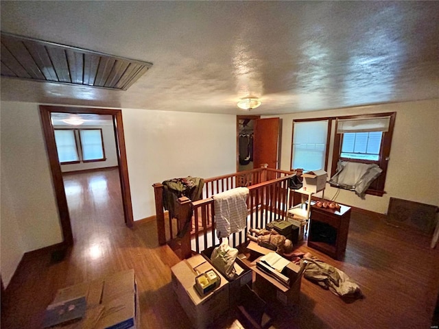 interior space featuring a textured ceiling and hardwood / wood-style flooring