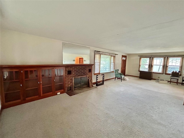 interior space featuring carpet flooring and a brick fireplace