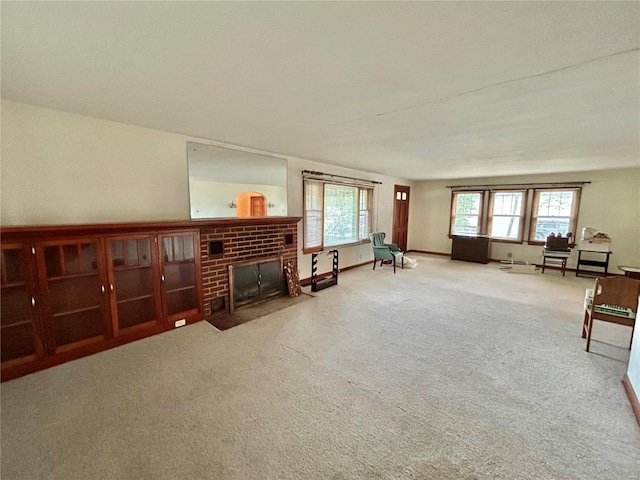 living room with plenty of natural light, a fireplace, and carpet