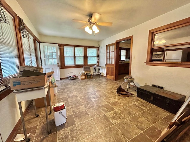 interior space featuring ceiling fan