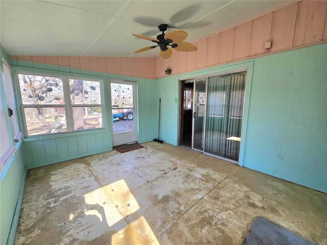 unfurnished sunroom featuring ceiling fan and vaulted ceiling