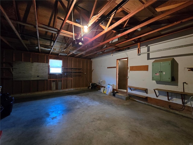 garage with a garage door opener and electric panel