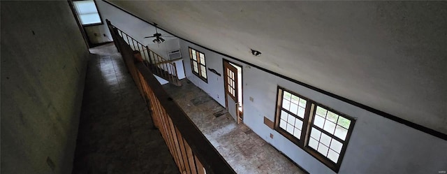 stairway with crown molding, hardwood / wood-style flooring, and ceiling fan