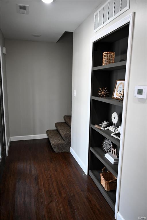 corridor featuring dark wood-type flooring