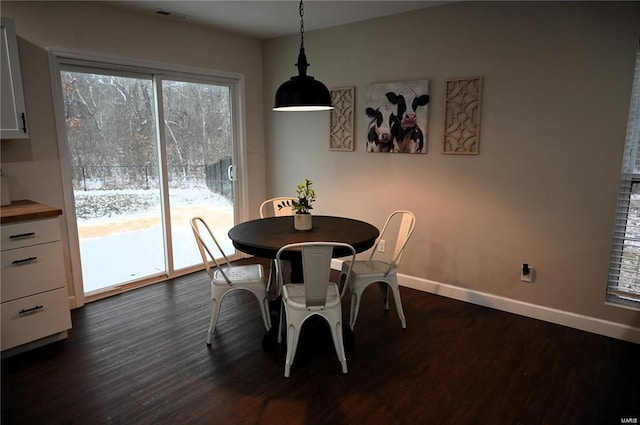 dining space with dark hardwood / wood-style floors