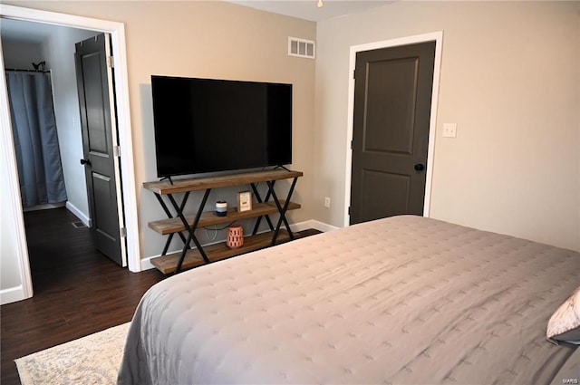 bedroom with dark hardwood / wood-style floors