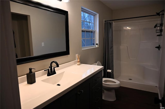 bathroom featuring vanity, toilet, curtained shower, and hardwood / wood-style floors