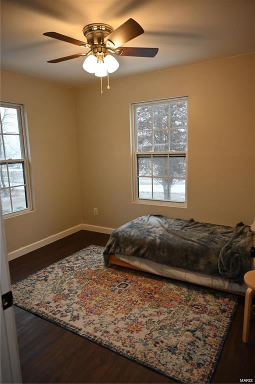 bedroom with dark wood-type flooring and ceiling fan