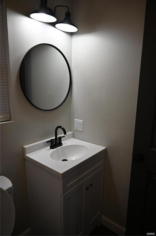 bathroom featuring vanity and toilet