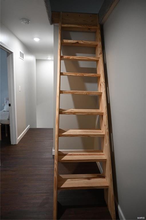 stairs featuring wood-type flooring