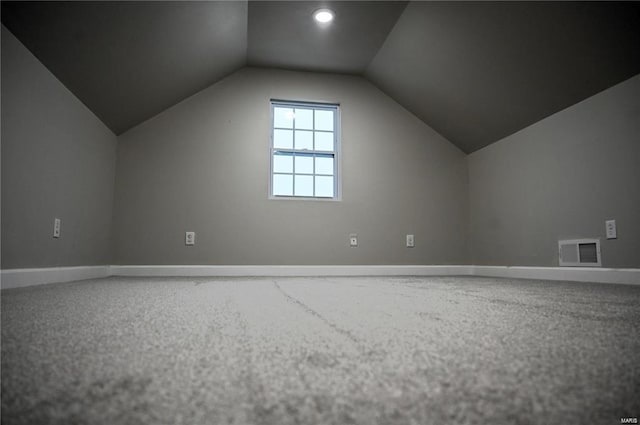 bonus room with carpet and vaulted ceiling