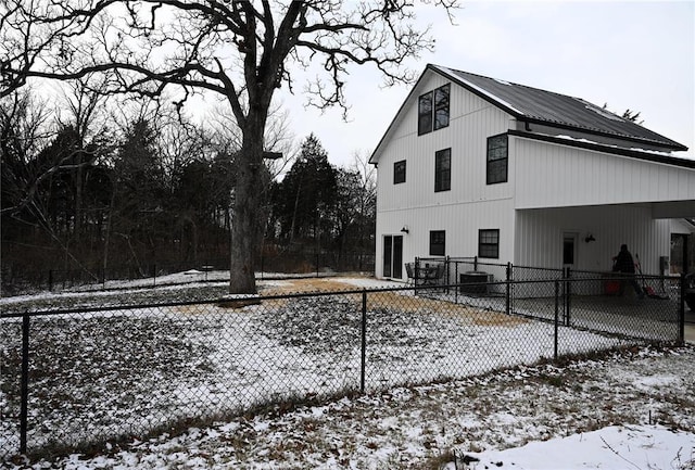 snow covered property with a carport