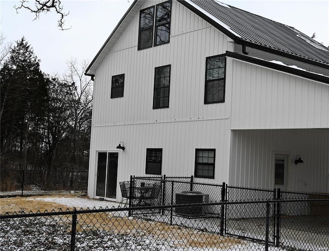 view of side of property featuring cooling unit and a patio area