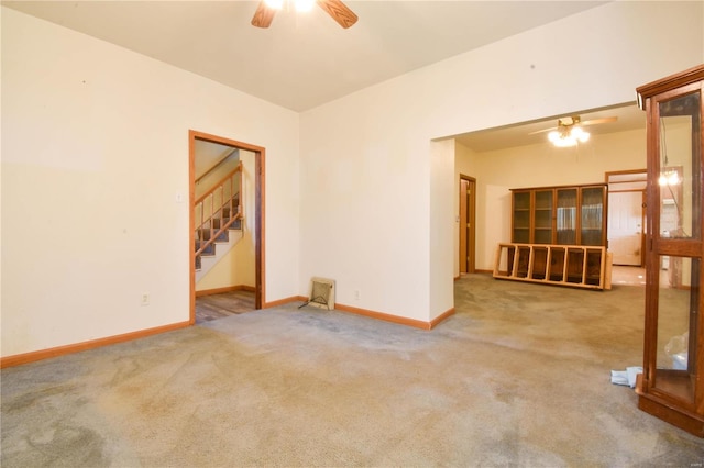 unfurnished room featuring ceiling fan and light colored carpet