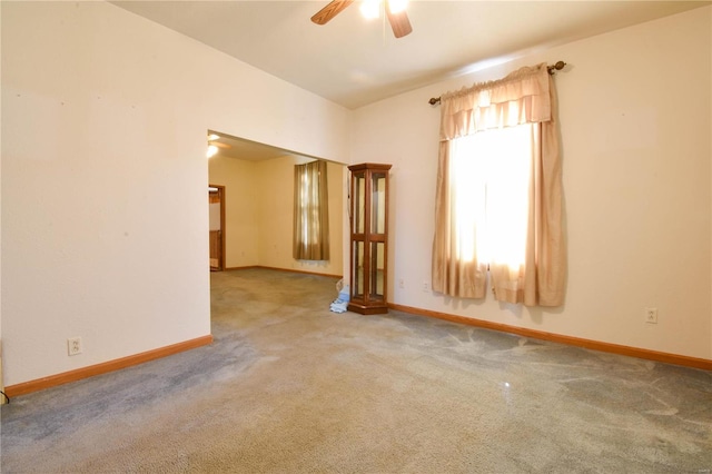 unfurnished room with ceiling fan and light carpet