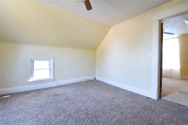 additional living space with carpet flooring, ceiling fan, and lofted ceiling