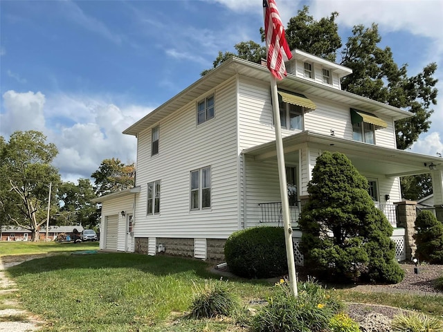 view of property exterior featuring a lawn and covered porch