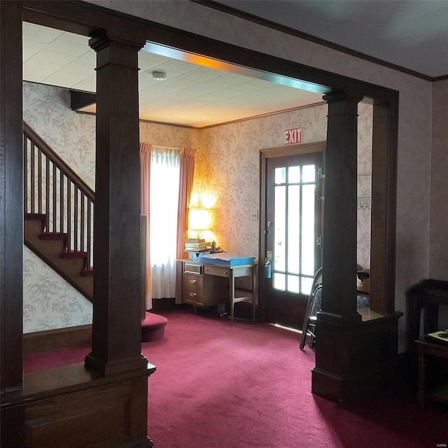 interior space featuring carpet floors, crown molding, and decorative columns