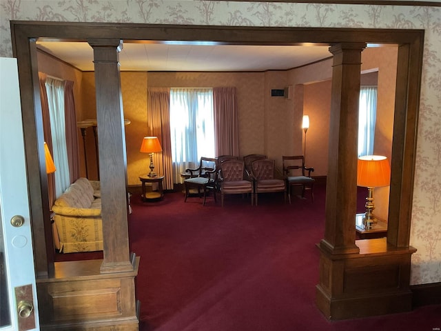 living room with dark carpet and ornate columns