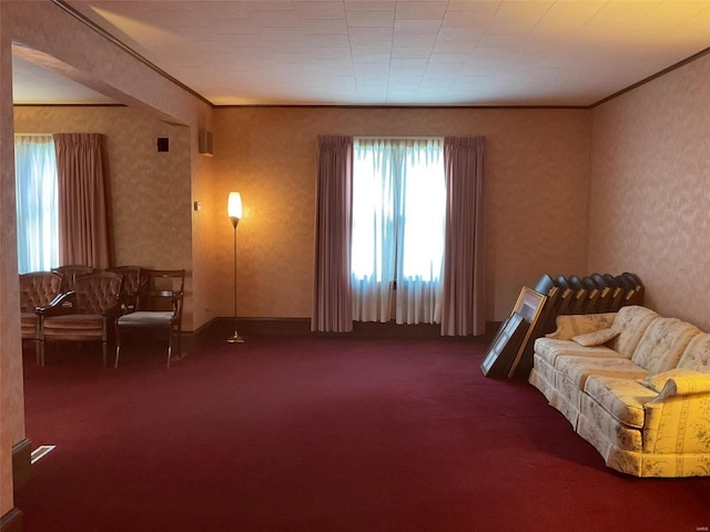 sitting room featuring ornamental molding and carpet floors