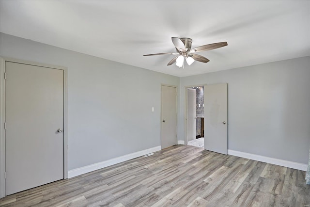 spare room featuring ceiling fan and light hardwood / wood-style flooring