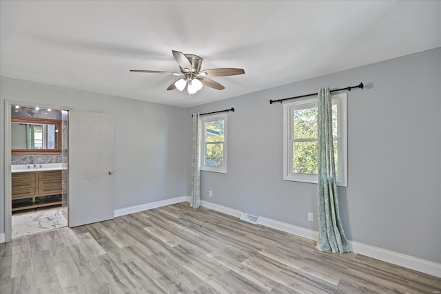 spare room with ceiling fan and light hardwood / wood-style flooring