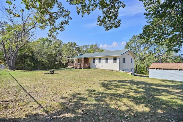 view of front of house featuring a front yard and a deck