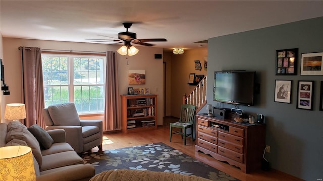 living room featuring light wood-type flooring and ceiling fan