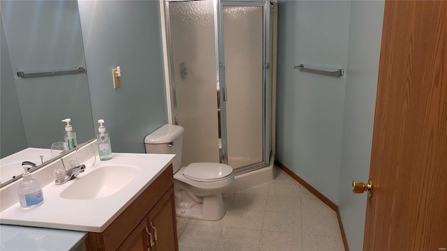 bathroom with toilet, a shower with door, and vanity