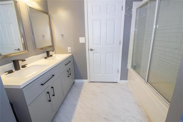 bathroom featuring vanity and bath / shower combo with glass door