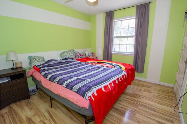 bedroom with light hardwood / wood-style floors and ceiling fan