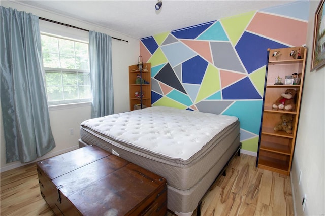 bedroom with light hardwood / wood-style floors