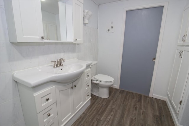 bathroom featuring backsplash, vanity, wood-type flooring, and toilet