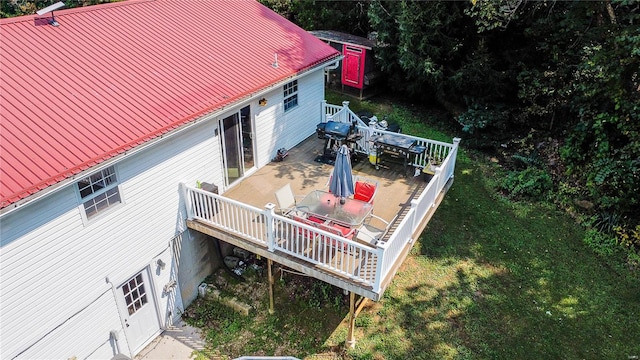 wooden deck featuring a lawn