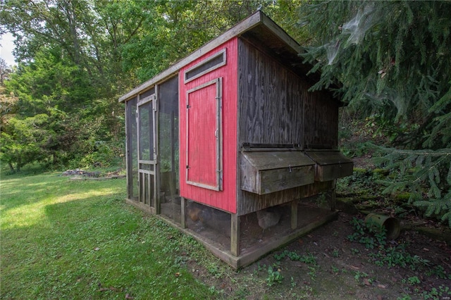 view of outbuilding with a lawn