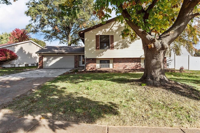 tri-level home with a front lawn and a garage