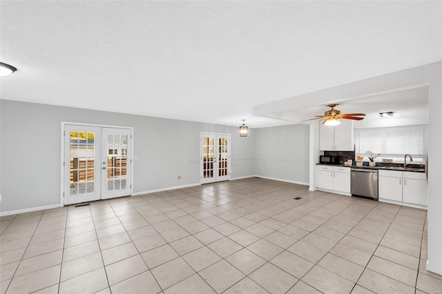 unfurnished living room with french doors, ceiling fan, and light tile patterned flooring