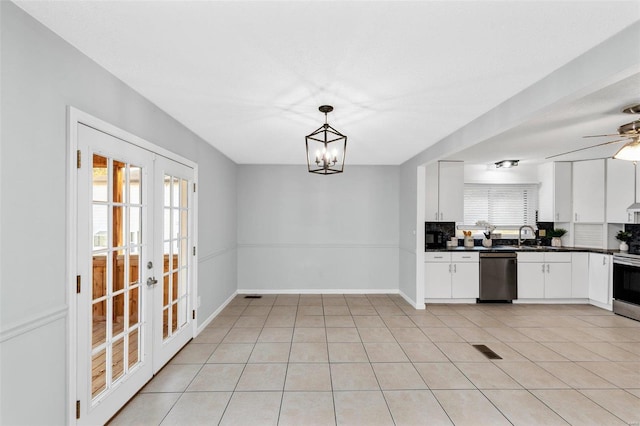 kitchen with french doors, hanging light fixtures, stainless steel appliances, white cabinets, and decorative backsplash