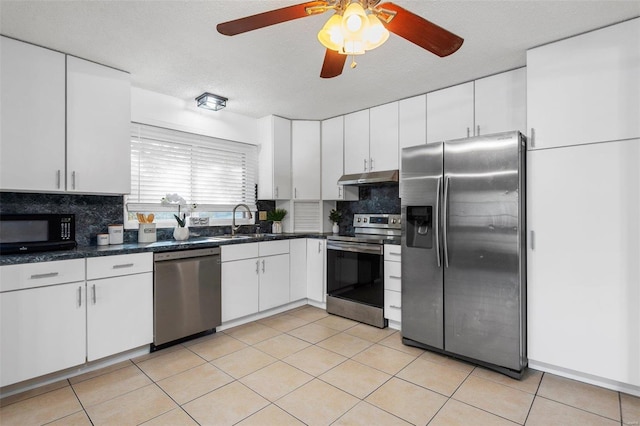 kitchen with tasteful backsplash, appliances with stainless steel finishes, and white cabinets