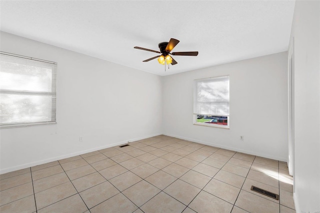 tiled empty room with ceiling fan