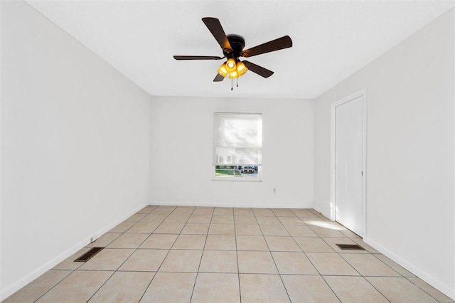 spare room featuring light tile patterned flooring and ceiling fan