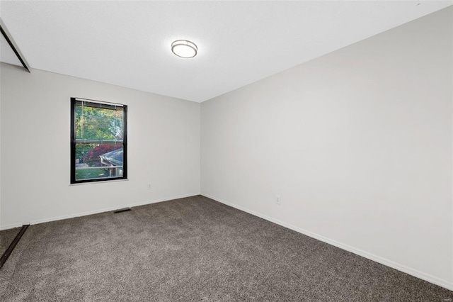 carpeted spare room featuring a textured ceiling