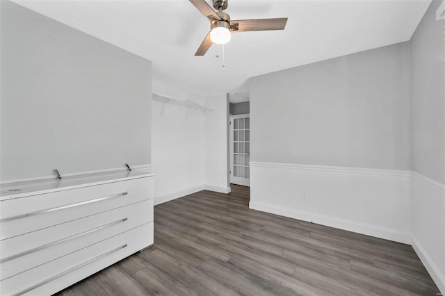 unfurnished room featuring ceiling fan and dark hardwood / wood-style flooring