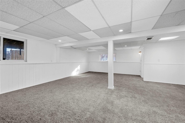 basement featuring carpet floors and a paneled ceiling