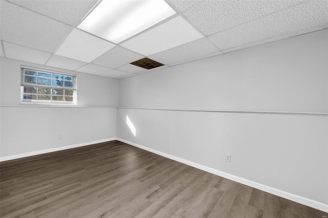 basement featuring hardwood / wood-style flooring and a paneled ceiling