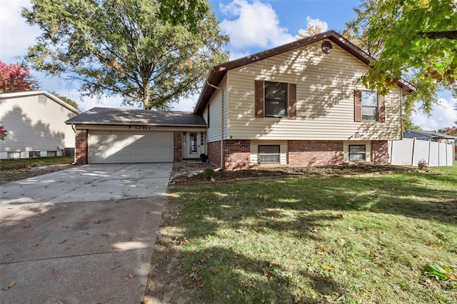 tri-level home featuring a garage and a front lawn