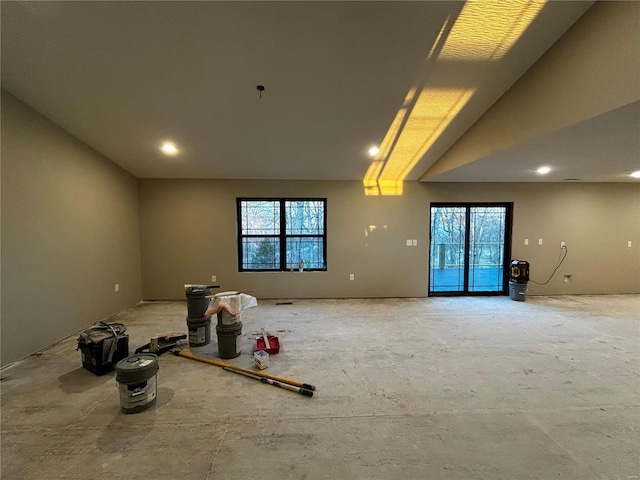 unfurnished room featuring vaulted ceiling and a wealth of natural light