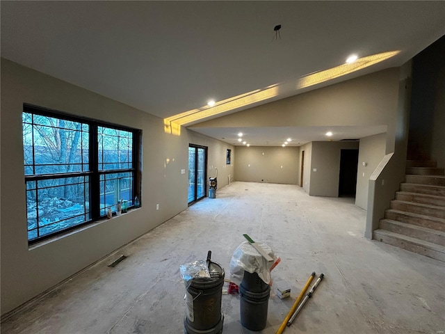 empty room with high vaulted ceiling, recessed lighting, visible vents, and stairs